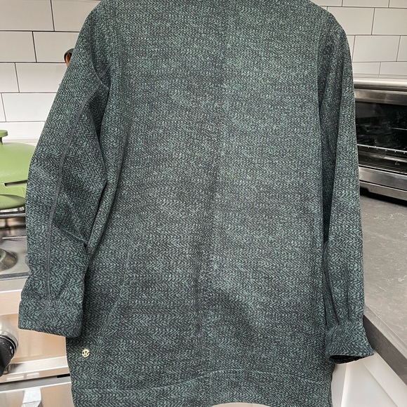 This is a lululemon cocoon coat in the color green with specs of black. - Picture 2 of 7